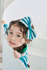 Momohanipopo Stripe Hairband featuring an oversized knit bow with teal and off-white stripes and a solid teal center.