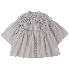 The Cotton Chiffon Blouse from Fith. Light grey blouse with a mandarin collar, button front, and gathered ruffle detailing.