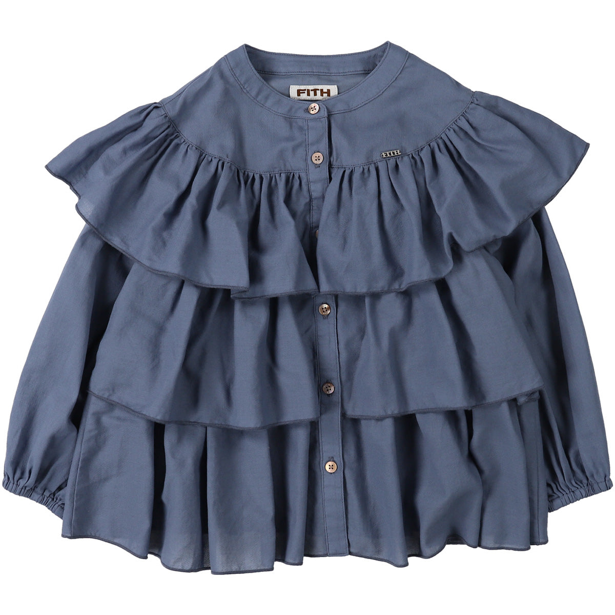 The Cotton Chiffon Dobby Blouse from Fith. Girls’ blue blouse with tiered ruffles and button-down front.