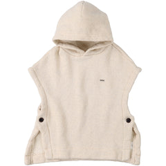The Low Gauge Pile Vest from Fith. A cream hooded poncho with cap sleeves, side button details.