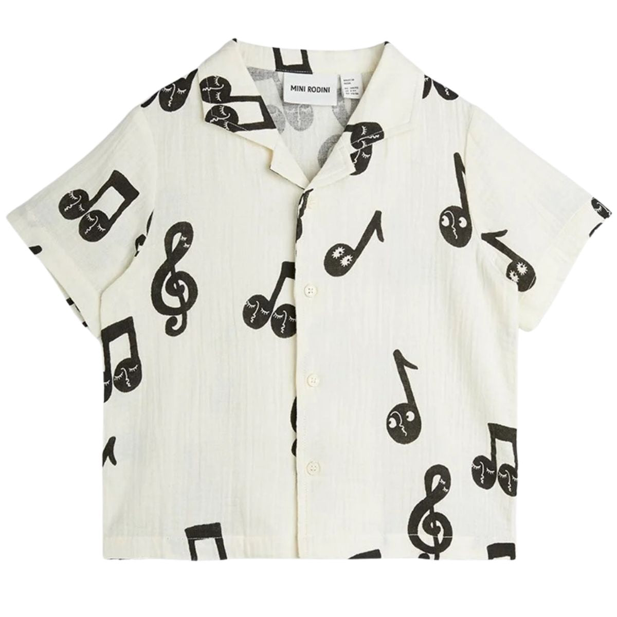 The Note Muslin Shirt from Mini Rodini. Short sleeve muslin shirt with a cuban collar and button closure.