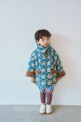 Momohanipopo Paprika Short Coat featuring a green geometric print, plush brown teddy fleece collar, and front pockets.