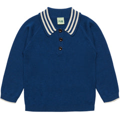 The Harlekin Polo from FUB featuring a textured harlequin knit pattern, striped flat collar, and corozo nut buttons.