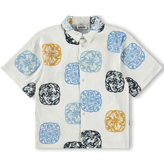 The Richie Shirt by Molo, off-white short-sleeve button-up with an all-over circular motif print in blue, black, and mustard.