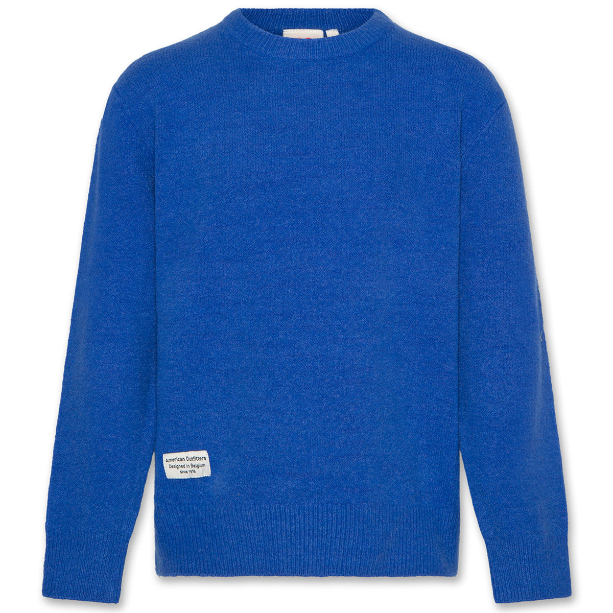 The Junior C Neck Elbow Sweater from AO76. Blue cozy knit sweater with a label.