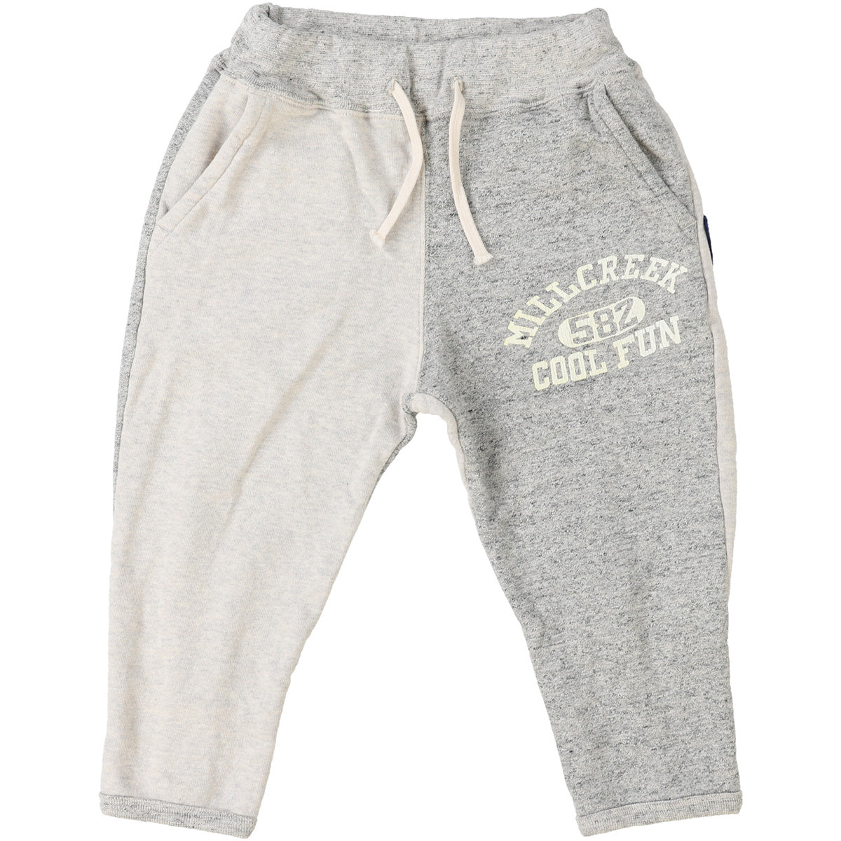 The Pennant Sweatpants from Denim Dungaree. Gray sweatpants with white text on a white background.
