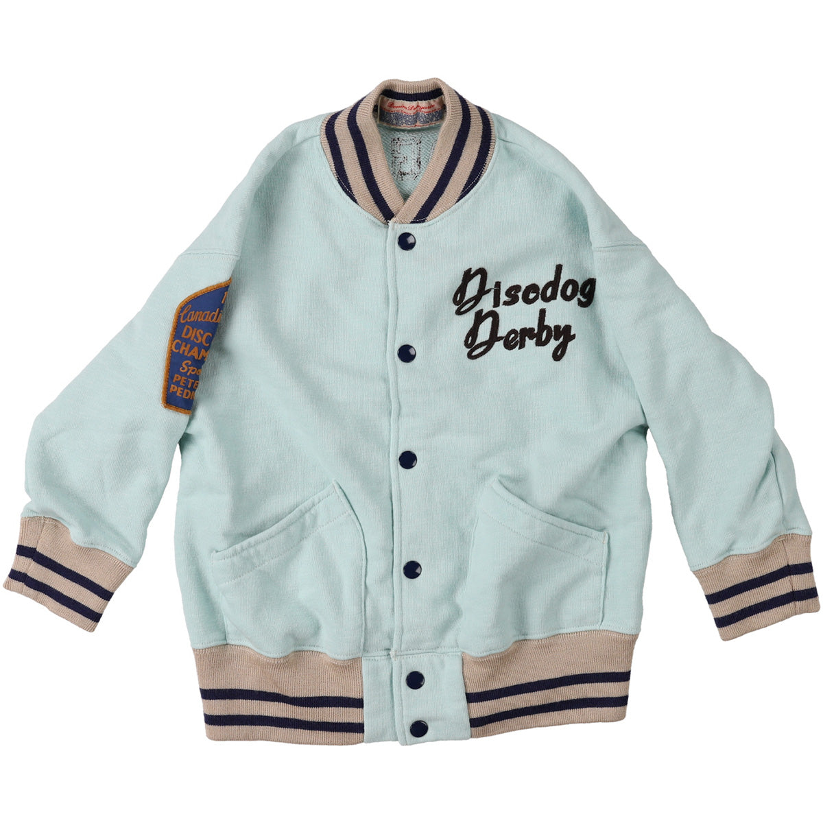 The 1959 Sweat Jacket by Denim Dungaree. Mint green kids’ varsity jacket with navy text embroidery and sleeve patch.