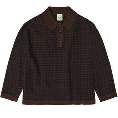 The Checked Polo from FUB. It features a flat shirt collar, folded hems, and a front button closure with corozo nut buttons.