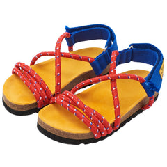 Arandano Sandals by Maison Mangostan feature a red rope upper and easy-to-fasten blue velcro closure at the ankle.