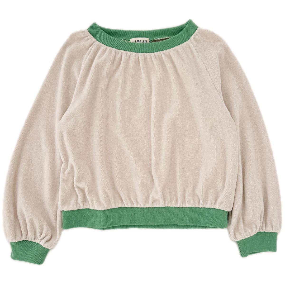 The Velvet Sweater from Long Live the Queen features a soft beige body with contrasting green ribbed cuffs and hem.