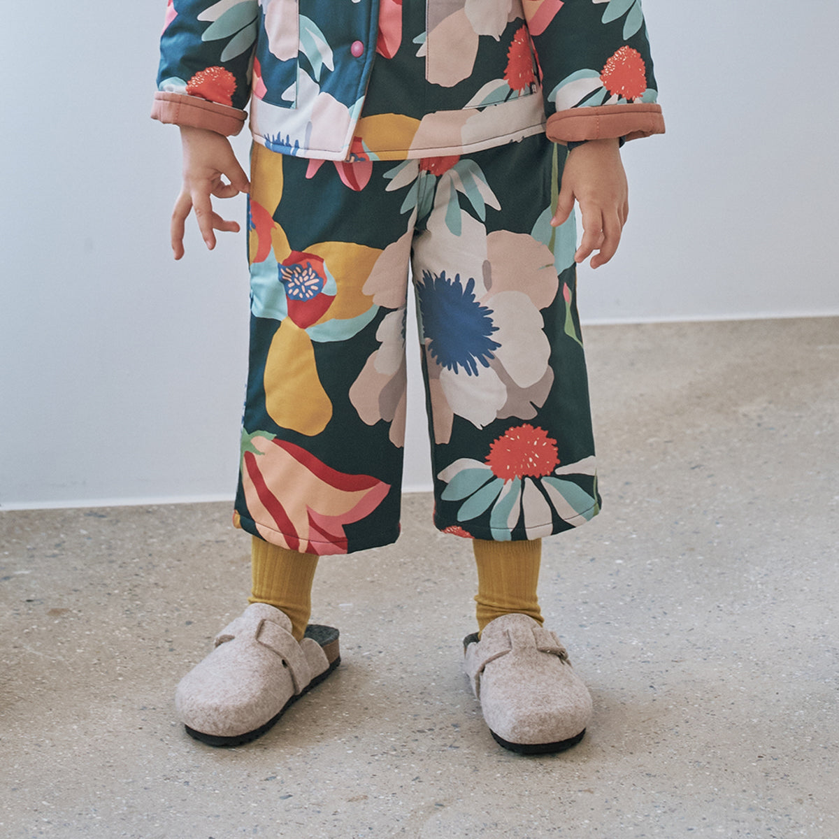 Momohanipopo Multiflower Padded Pants featuring a colorful floral graphic print, wide-leg cut, and soft padded texture.
