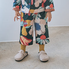 Momohanipopo Multiflower Padded Pants featuring a colorful floral graphic print, wide-leg cut, and soft padded texture.