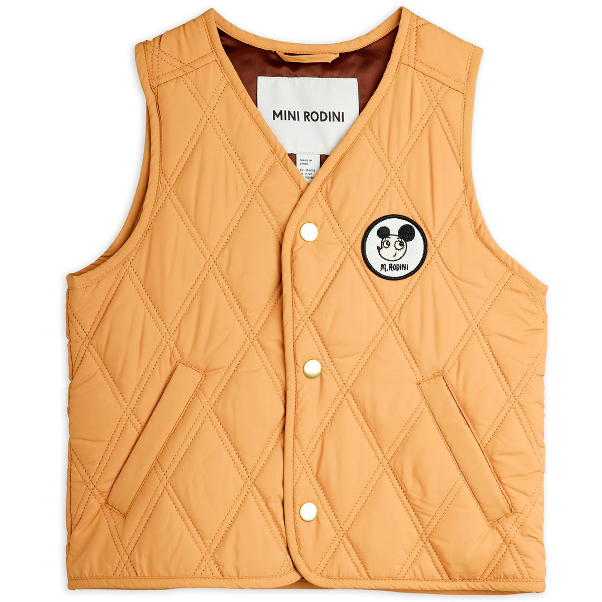 The Ritzratz Quilted Vest from Mini Rodini. Light brown quilted vest with an embroidered patch logo.