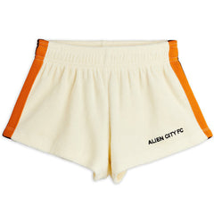 Mini Rodini Alien City FC cream sweatshorts with orange side stripes and logo print