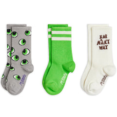 Mini Rodini three-pack socks with green eye print, green striped pair, and cream logo design