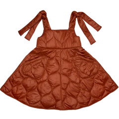 Paade Mode Felix Puffer Pinafore Dress in caramel quilted fabric featuring adjustable shoulder bow ties and patch pockets.