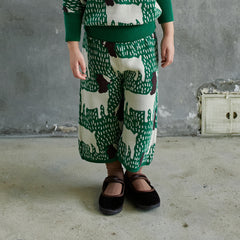 The Goat Pants from Momohanipopo. Green knitted pants with cream and brown animal patternใ