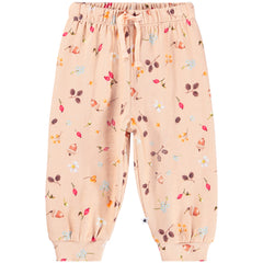 The Simeon Sweatpants from Molo. The pants are pink with a print of nuts, flowers and berries.