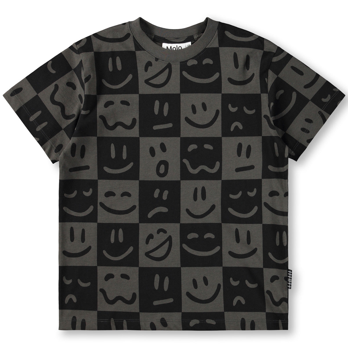 The Riley Tee from Molo. T-shirt with smiley face pattern on a checkered background.