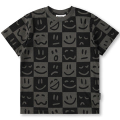 The Riley Tee from Molo. T-shirt with smiley face pattern on a checkered background.