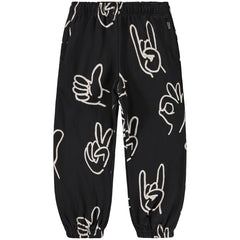 The Adan Sweatpants from Molo. Black pants with white hand gesture prints.