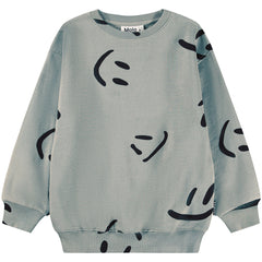The Monti Sweatshirt from Molo. Beige sweatshirt made of soft organic cotton with a print of smiling faces.