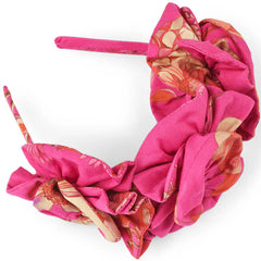 Pink Floral Hairband from Christina Rohde. The vibrant pink floral fabric with ruffled detailing adds a playful and stylish touch.