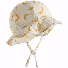 The Noel Hat from Molo features a playful banana print on a soft, cream-colored base.