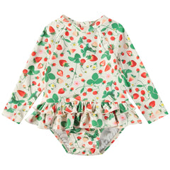 The Narice Swimsuit from Molo. Long-sleeve baby swimsuit with a sweet strawberry print and ruffled waist.