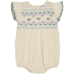 The Hand Smocked Embroidered Romper from Emile et ida. It exudes vintage charm with smocking and floral embroidery.