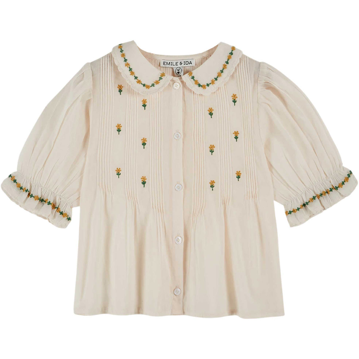 The Embroidered Blouse by Emile et Ida, cream blouse with puff sleeves, Peter Pan collar, and small floral embroidery.