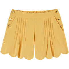 The Embroidered Shorts by Emile et Ida, yellow pleated shorts with scalloped hem and delicate floral embroidery.