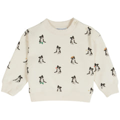 Cream sweatshirt with long sleeves, ribbed cuffs and hem, and allover small dog print