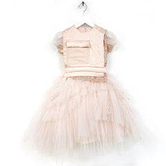 The Adelia Dress from Anja Schwerbrock. A dreamy dress featuring puff sleeves, a layered tulle skirt with pocket detail.