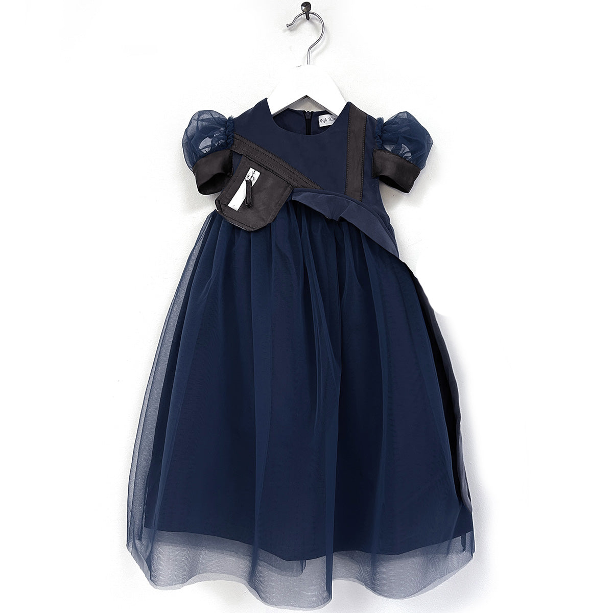 The Aria Dress from Anja Schwerbrock. A charming kids’ dress in deep navy, designed with puff sleeves, a full tulle skirt.