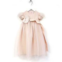 The Aria Dress from Anja Schwerbrock. A delicate kids’ dress in soft rose pink, featuring puff sleeves, layered tulle skirt.