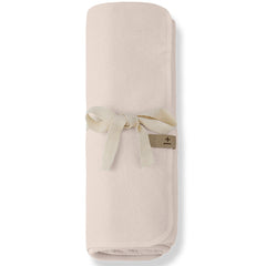 The Asis Blanket from 1+ in the Family, a soft baby blanket in lightweight textured fabric tied with a ribbon.