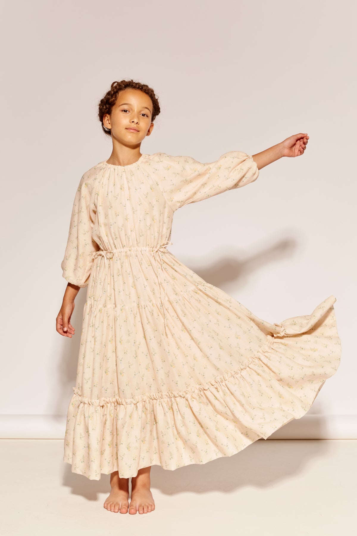The At The End Of The Day Dress by The Middle Daughter in cream floral print with tiered maxi silhouette.
