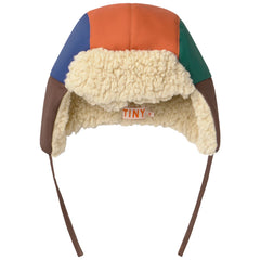 The Color Block Chapka from Tiny Cottons. Color-block trapper hat in orange, blue, green, and brown panels.