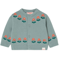 The Flowers Baby Cardigan from Tiny Cottons. Green knitted cardigan with floral patterns on a white background.
