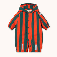 A hooded baby one-piece by designer Tiny Cottons with bold vertical stripes in orange-red and dark green, featuring a snap-button front, elastic cuffs, and reflective silver stripes near the hem.