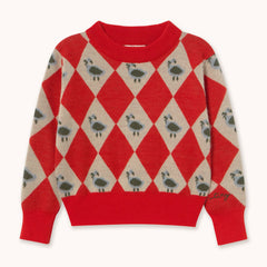 A red and beige argyle sweater by designer Tiny Cottons featuring a pattern of small birds in each altrenating red diamond, with solid red ribbed trim at the collar, cuffs, and hem.