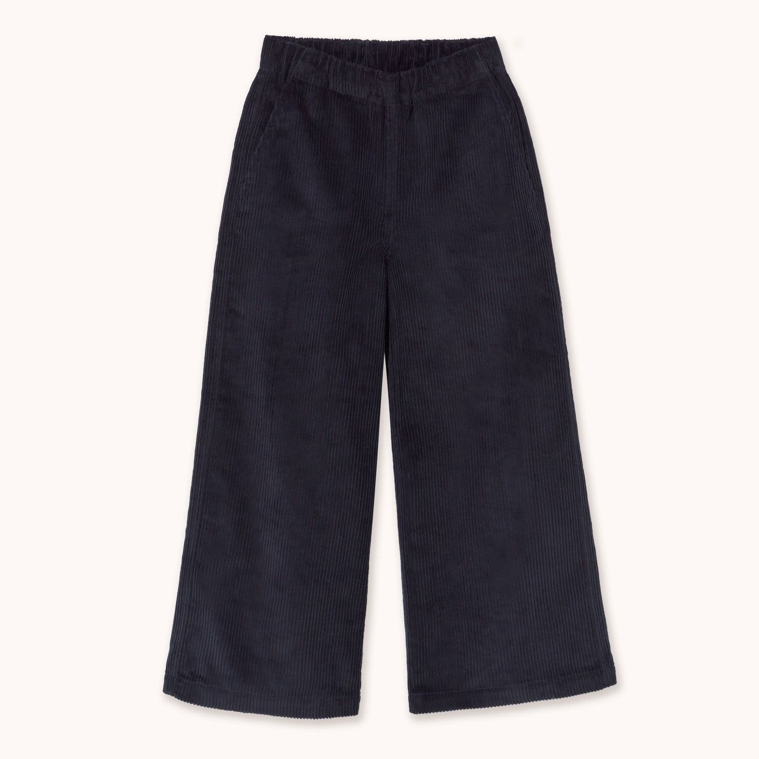 A pair of dark navy corduroy cropped pants with an elastic waistband by designer Tiny Cottons, shown flat against a light cream background.
