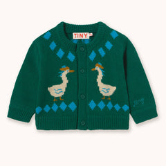 A green knit cardigan sweater by designer Tiny Cottons with blue diamond patterns and two cream-colored ducks with orange beaks, shown flat on a light cream background. The brand label 'TINY' is visible inside the collar.