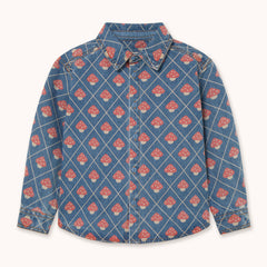 A long-sleeve button-up shirt by designer Tiny Cottons in blue denim featuring a repeating pattern of red and white mushrooms inside a diamond grid design, shown flat against a light cream background.