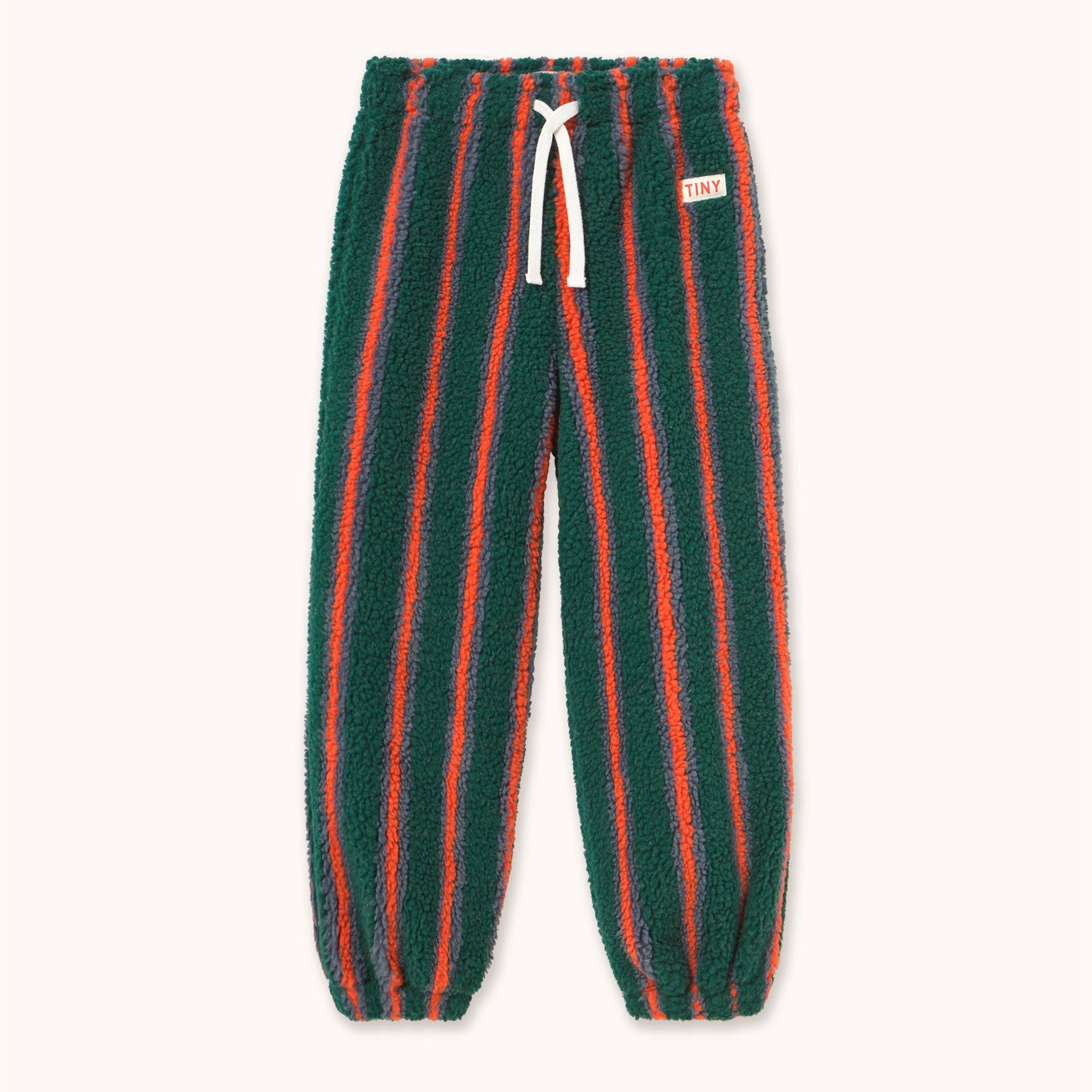 A pair of dark green fleece jogger pants with vertical orange-red stripes by designer Tiny Cottons, featuring a white drawstring and a small white brand tag on the left hip.