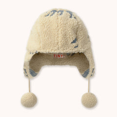 Cream colored children's hat  with earflaps and pompoms by designer Tiny Cottons.