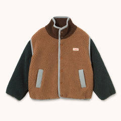 A children's sherpa fleece jacket with a brown body, dark green sleeves, and light gray trim, featuring a small 'TINY' brand patch on the chest by designer Tiny Cottons.