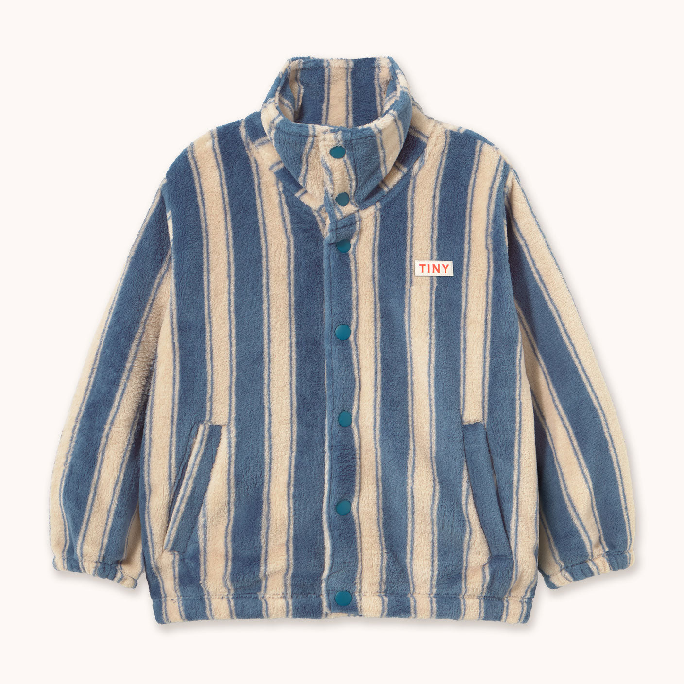A striped fleece jacket with vertical blue and cream stripes by designer Tiny Cottons, featuring a high collar, button-up front, and a small 'TINY' brand patch on the chest, displayed on a clean off-white background.