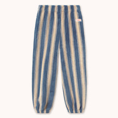 Blue and beige vertically striped fleece pants by designer Tiny Cottons with an elastic waistband and cuffs, featuring a small red and white 'TINY' brand patch on the upper right hip.